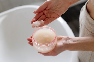 Body and head textured scrub in female hands.