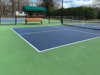 Outdoor permanent striped green and blue pickleball courts