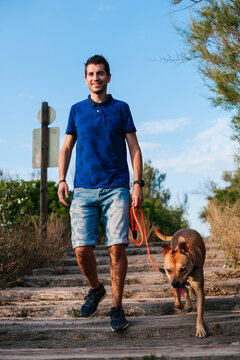 Man with dog walking on steps