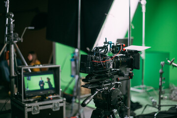 Film set, monitors and modern shooting equipment. Film crew, lighting devices, monitors, playbacks - filming equipment and a team