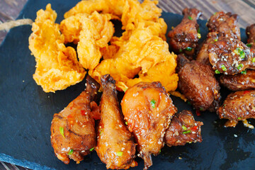 caramelized chicken with sesame and garlic, meat strips in breadin.