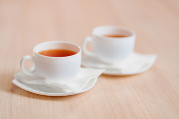 two white cups of tea on the table. the concept of a break at work. 