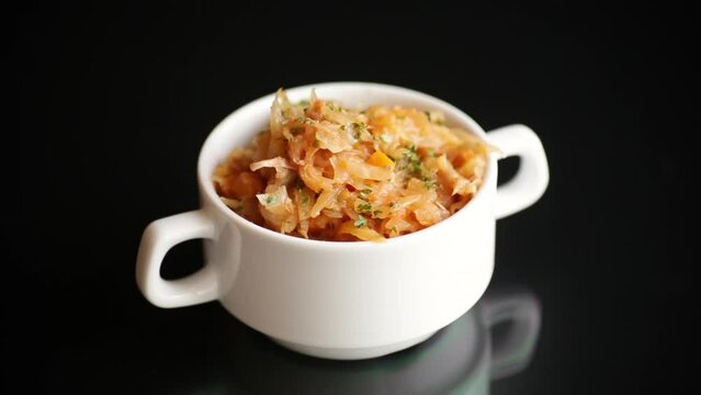 stewed cabbage with carrots and spices in a bowl