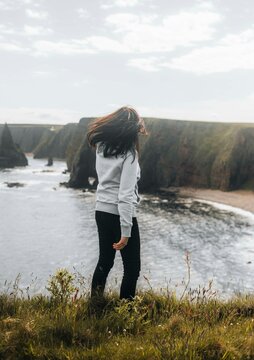 Woman relaxing at Sea Stacks At Duncansby Head. Highlands, Scotland