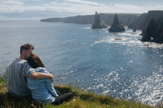 Couple in love looking on the Sea, Stacks At Duncansby Head. Scotland