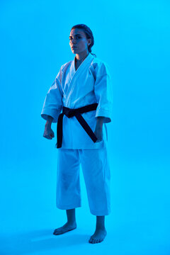 Woman in Karate uniform under blue light