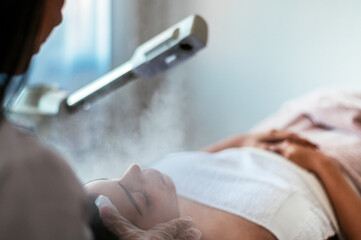 Beauty treatment with ozone facial steamer
