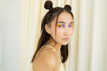 Young Asian female model with colorful makeup