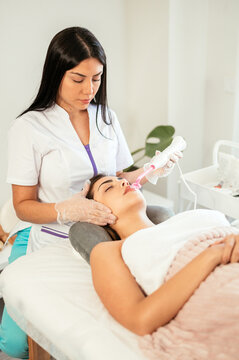 woman specialist doing darsonvalization