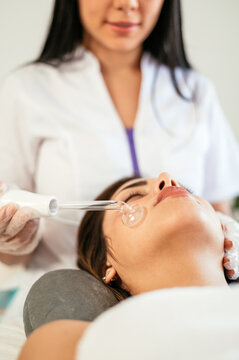 Faceless specialist doing darsonvalization