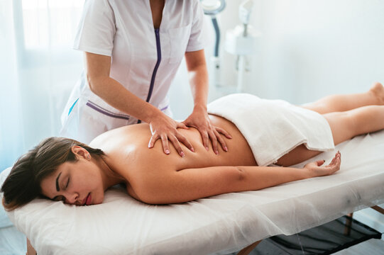 Masseuse doing massage to client