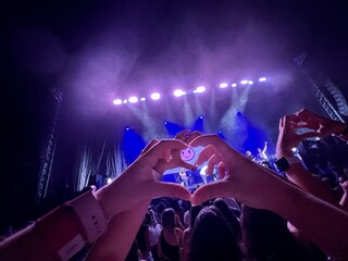 Hands making heart in concert. Heart hands concept in concert