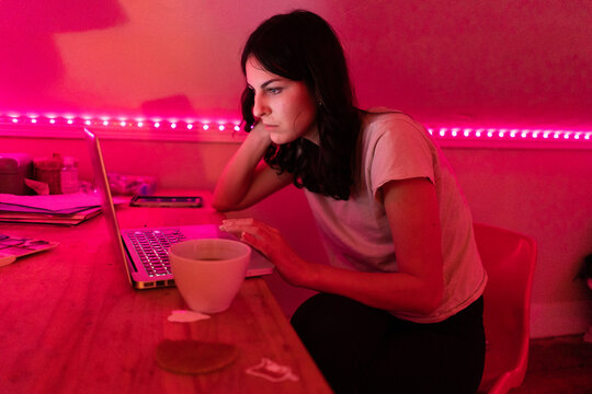 student focused on her laptop