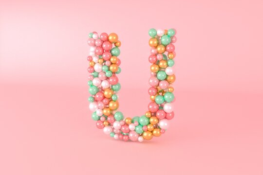 Letter U made of glass balls, pastel pearls, crystal jewels and gold.