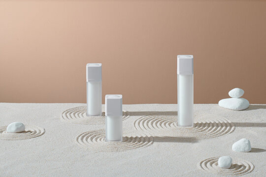 Spa therapy cosmetic products with zen stones on sand