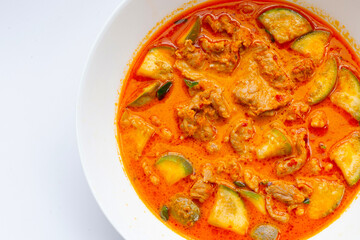 Red curry round eggplant with pork, white background. Copy space