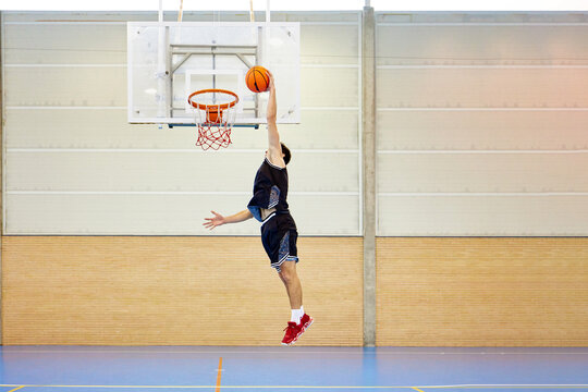 Basketball player throwing ball into hoop
