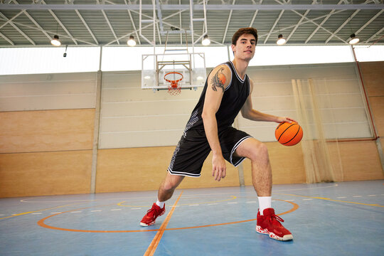 Young basketball player dribbling ball