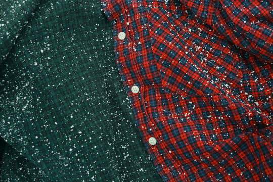 The snow is piling up on the checkered shirt.