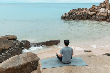 Young man practicing yoga and meditating.