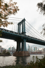 Hudson river with Manhattan bridge and modern skyscrapers of New York City on background.