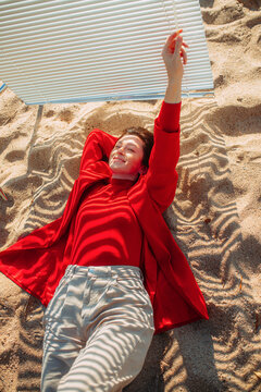 The girl smiles and protects her skin from sunlight