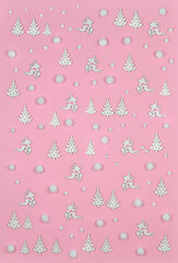 Pink fairy tale winter background for kids with jumping deers  ,pine trees and snowballs Top view, flat lay.