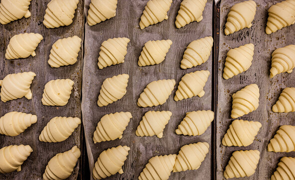 Raw croissants on baking paper