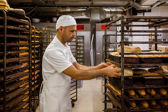 Man removing bread from pan