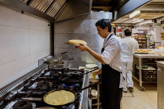 Cook with casserole making spanish omelette