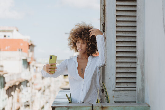 Charming woman taking selfie on smartphone