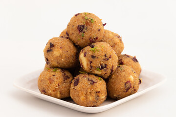 Indian Mithai Gulab Churma Ke Laddu Or Choorma Ke Ladoo Is Made Of Whole Wheat Jada Gehun Ka Atta, Khus Khus, Gur, Jaggery, Kaju, Badam, Edible Rose Petals, Dry Fruits In Desi Ghee Or Clarified Butter
