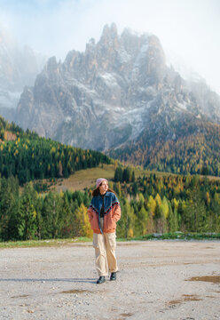 Woman traveling in Dolomites in autumn 