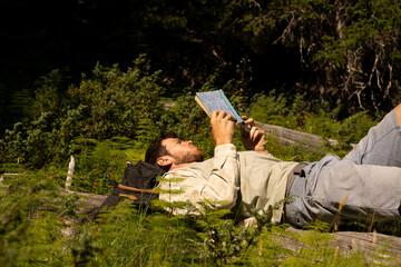 Man reading book in nature