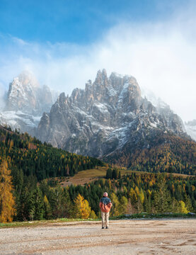 Woman traveling in Dolomites in autumn 