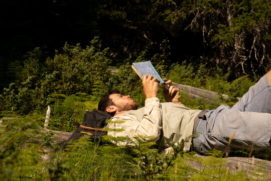 Man reading book in nature