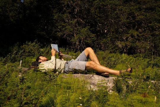 Man reading book in nature