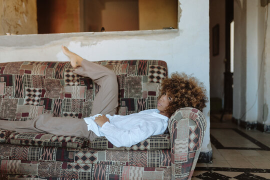 Cuban woman relaxing on couch