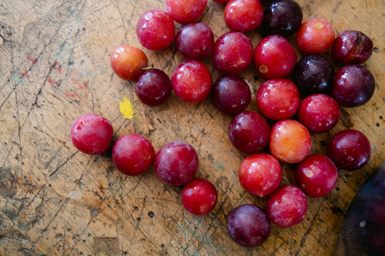 fresh plums on wooden table
