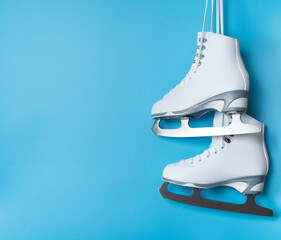 Ice skates shoes on blue background
