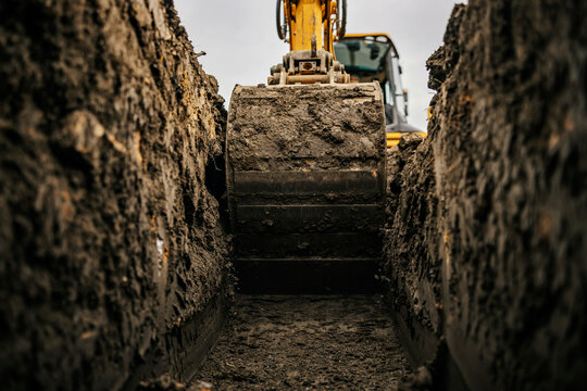 Close up of a bulldozer digging foundation on construction site.