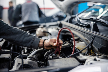 Fototapeta na wymiar Cropped picture of a mechanic doing car battery diagnostics.