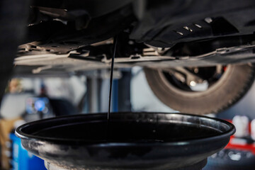 Fototapeta na wymiar Close up of oil draining from the car engine.