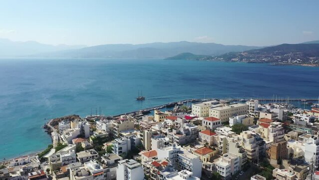 Aerial view of Agios Nikolaos, a picturesque coastal town with colorful buildings around the port in the eastern part of the island Crete, Greece