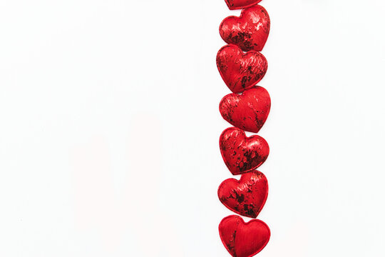 St. Valentine's Day. Red hearts on a white background, copy space. Background from lots of red hearts.