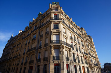 Fototapeta premium The facade of traditional French house with typical balconies and windows. Paris.