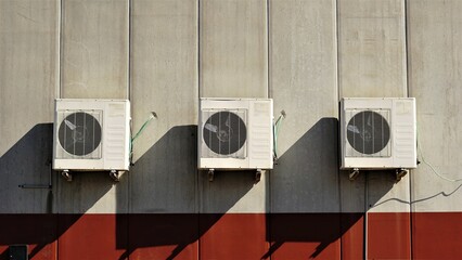 air conditioning compressors on cement facade