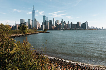 riverbank of Hudson river with skyscrapers of Manhattan in New York City.