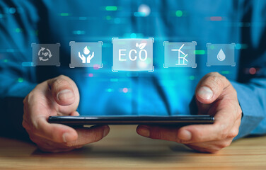 Eco concept , Business man holding smartphone for monitoring Eco ennergy concept