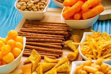 Naklejka na ściany i meble Party food. Salty snacks served as party food in bowls